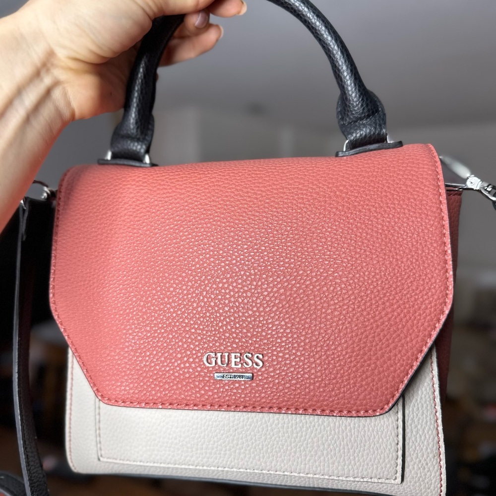 Pink and white Guess bag with a black strap